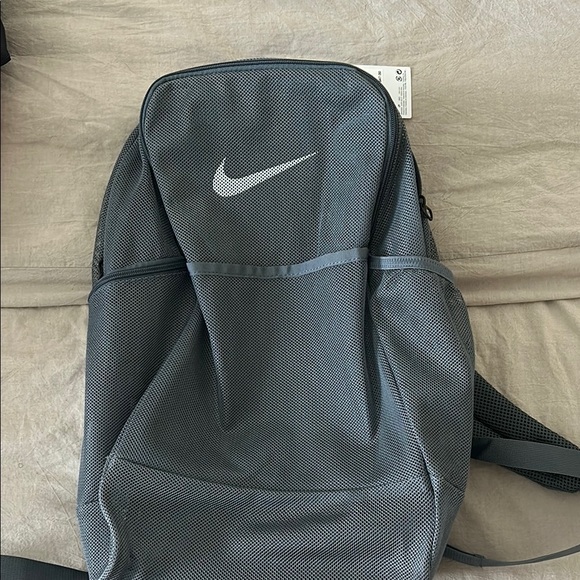 nike backpacks gray ELEMENTAL BACKPACK WOLF GREY - CLEARANCE Adjustable padded shoulder straps and the Nike Swoosh logo on the front Gray Adult Unisex Nike Backpack